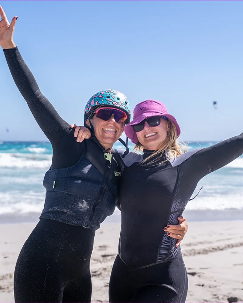 Two riders celebrating on the sand